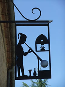 A glass blower sign above the artisan workplace and shop in Limeuil