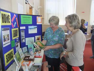 Elaine and a visitor look at the Hampshire County Council display of books and other items which cover the subject of dementia 