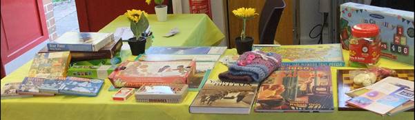 A selection of books games and twiddle muffs available at the Sunflower Cafe 