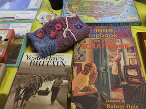 A selection of books, games and other items - including twiddle muffs available at the Sunflower Cafe