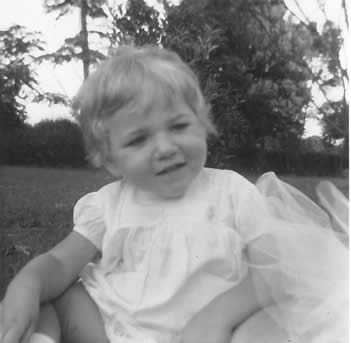 Louise looking thoughful whilst sitting on the grass